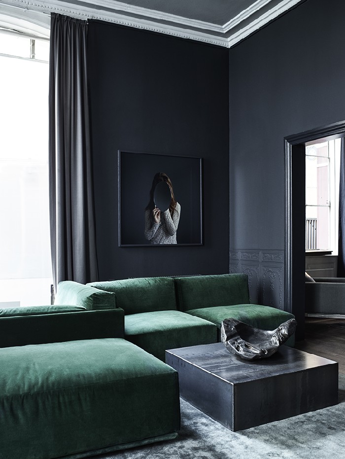 grey interiors with velvet green sofas